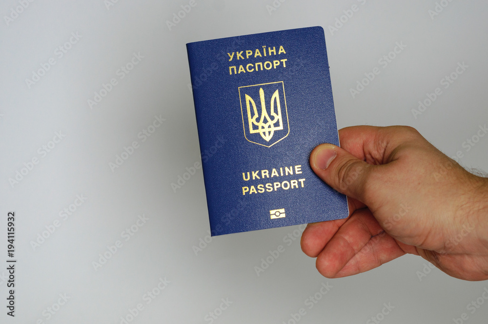 Blue Ukrainian passport in the hands of a man. Isolate Blue Ukrainian passport in the hands of a man. Isolate