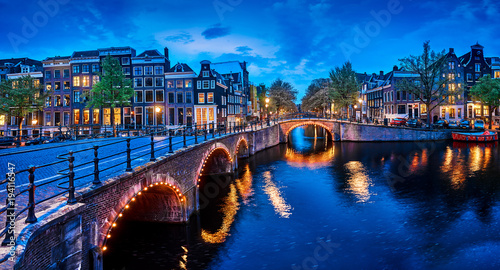 Bridge Blue hour arch over canal in Amsterdam Netherlands.