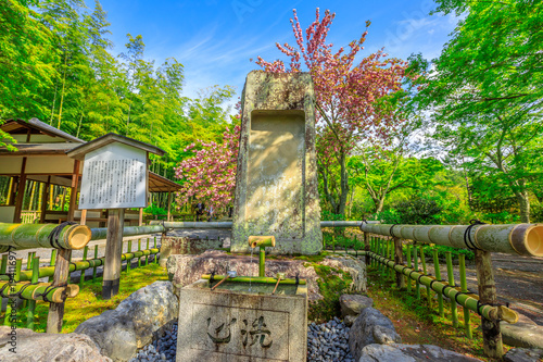 Kyoto, Japan - April 27, 2017: fountain in the Hyakka-en garden in the north side of Taho-den Hall inside Tenryu-ji, the most important Zen Temple in Arashiyama, Kyoto. Spring season in a sunny day. photo