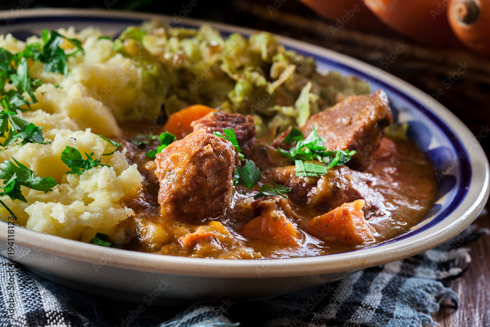 Traditional irish stew served with potatoes and cabbage