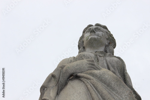 Stone marble religious statue in cemetery 