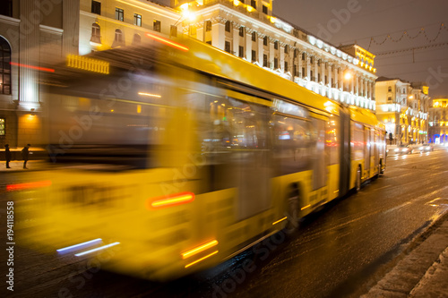 Blurred bus traffic on the avenue at night