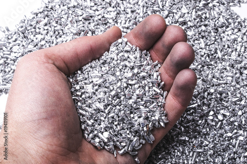 Hand mit Silber/Aluminium Granulat