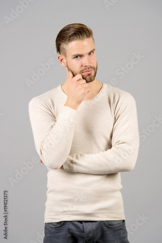 Guy touch beard on unshaven face, grooming