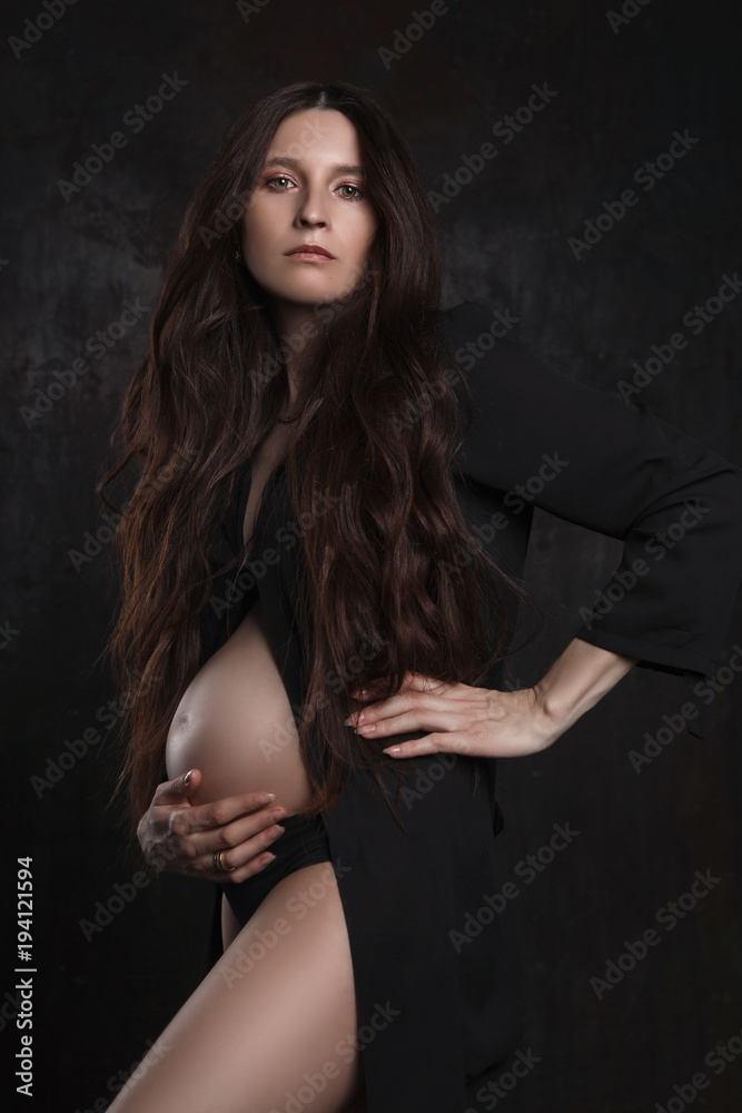 stylish portrait of pregnant woman on dark background