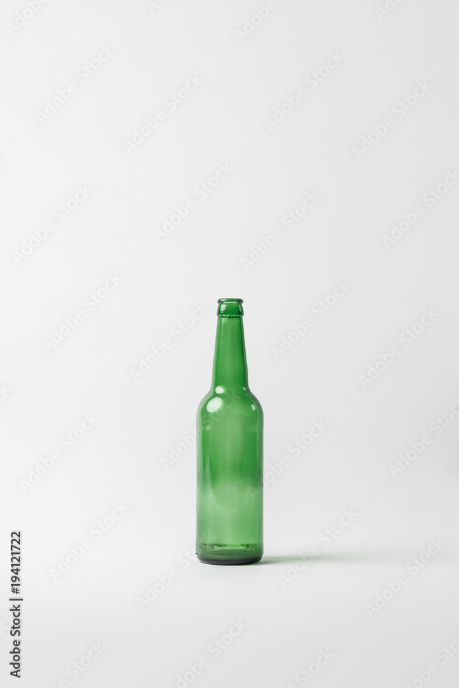 close up view of empty glass bottle isolated on grey, recycling concept close up view of empty glass bottle isolated on grey, recycling concept