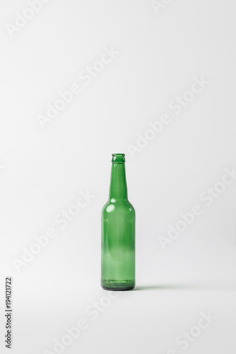 close up view of empty glass bottle isolated on grey, recycling concept