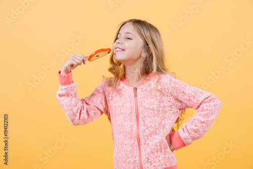 Candy girl pose on orange background