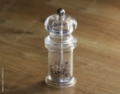glass Pepper mill set on wooden background