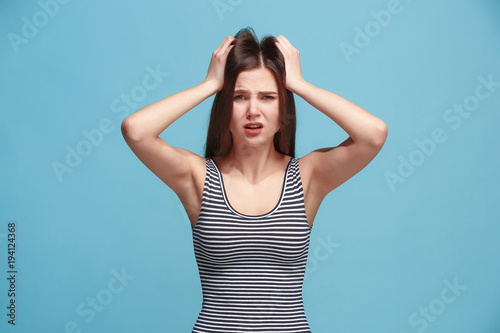 Woman having headache. Isolated over pastel background.