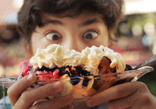 Banana split sundae ice cream in a bowl with strawberry and raspberry vanilla icecream scoops