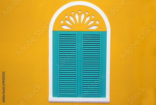 window on the yellow wall
