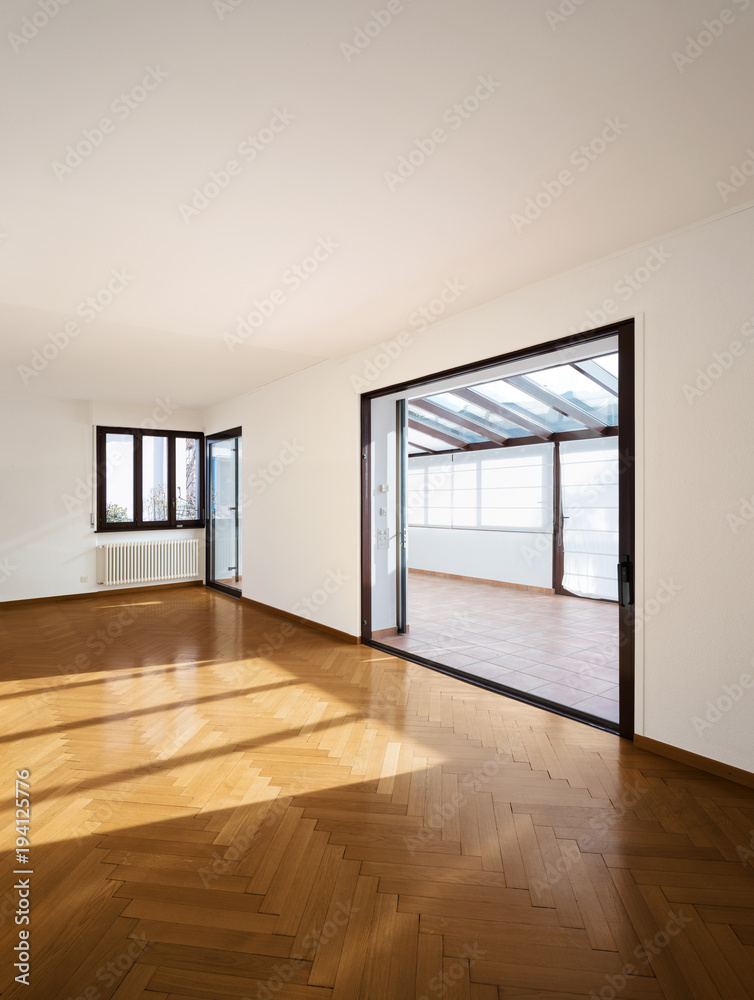 New room completely empty with wooden floors