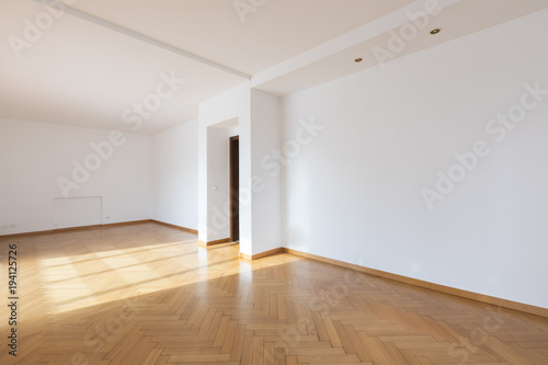 New room completely empty with wooden floors