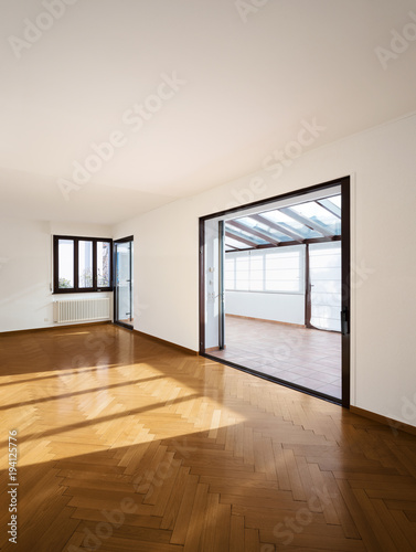 New room completely empty with wooden floors