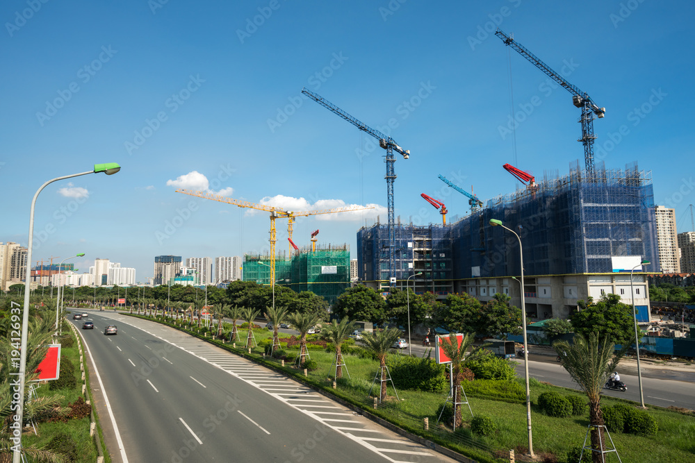 Modern city with highway traffic and building under construction. Hanoi city, Thang Long highway