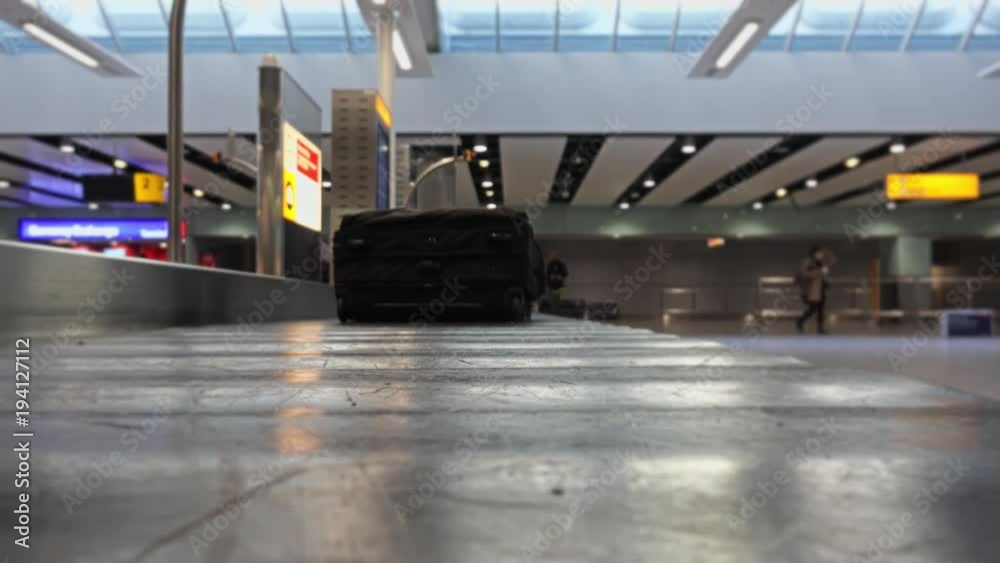 Bag Travels In Airport Baggage Claim Carousel. A baggage carousel is a