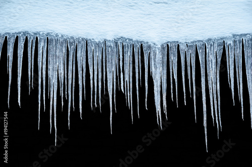 Icicles on an black background, isolated object.