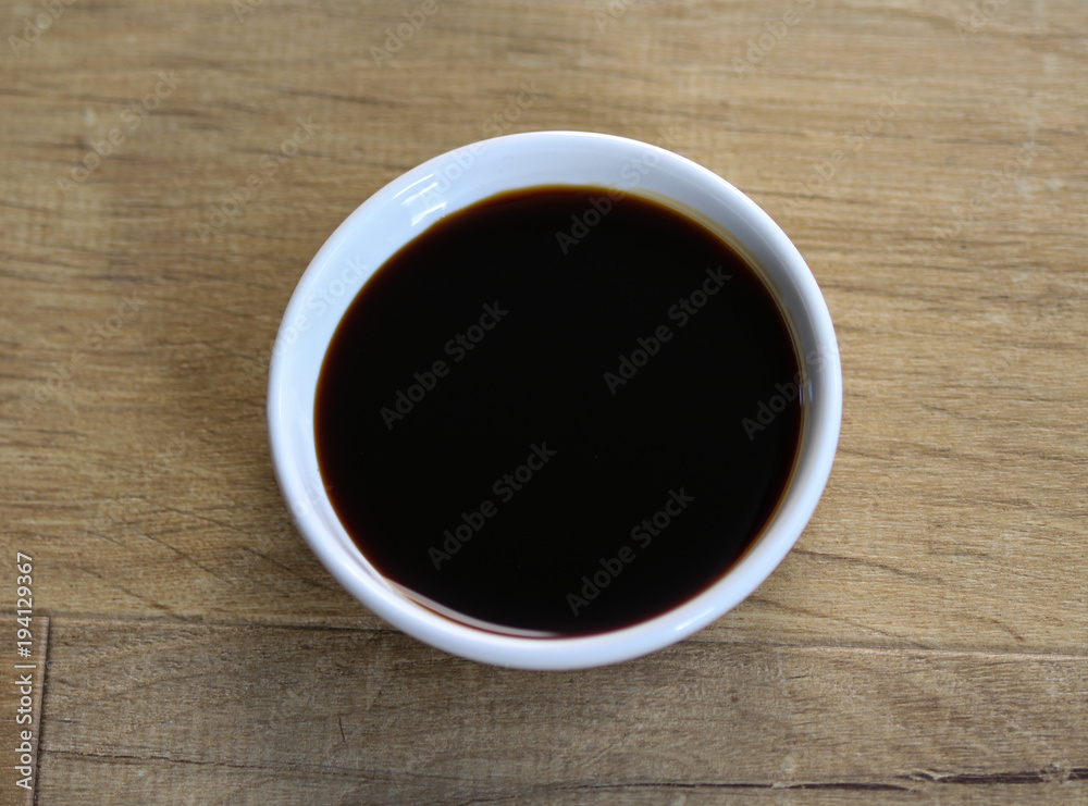 white bowl with sweet soy sauce on wooden background white bowl with sweet soy sauce on wooden background