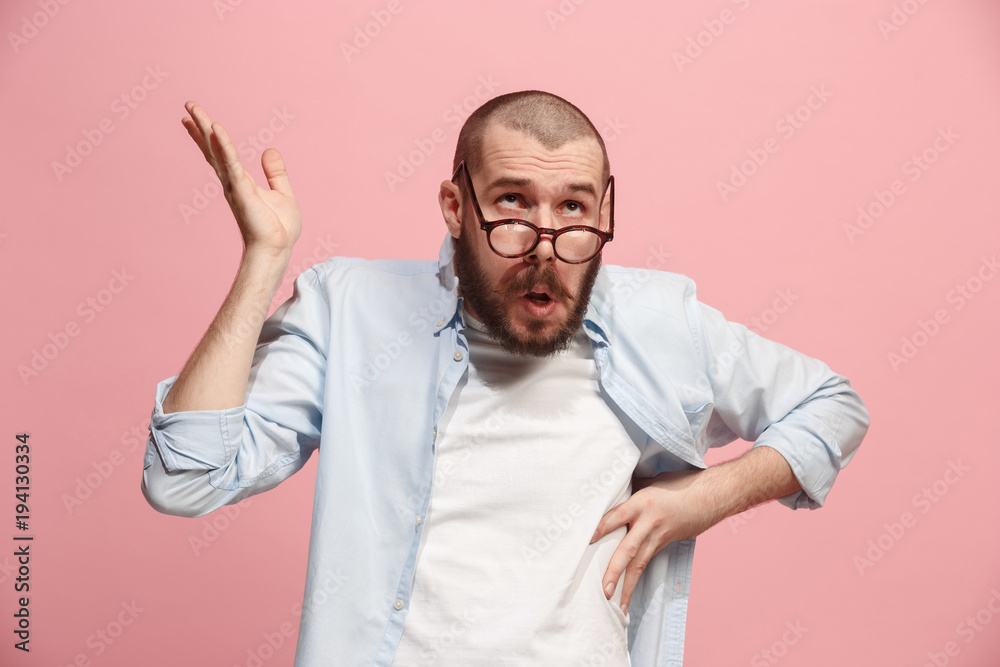 Let me think. Doubtful pensive man with thoughtful expression making choice against pink background Let me think. Doubtful pensive man with thoughtful expression making choice against pink background