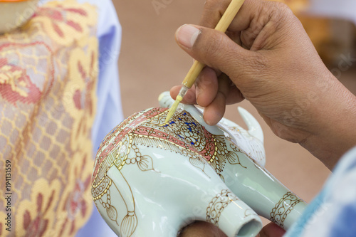 Close-up Specialist people working show the process of painting ceramic benjarong is traditional Thai, Bangkok Thailand. photo