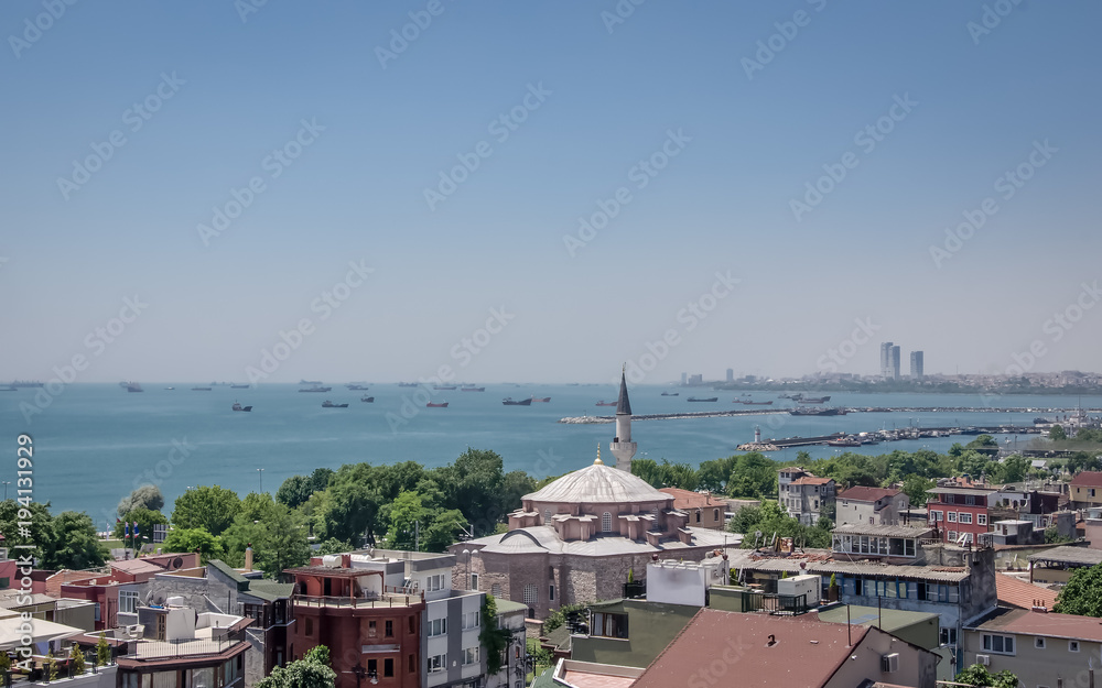 View of the Marmara Sea from the side of Fatih district of Istanbul. Little Hagia Sophia Mosque is in the foreground. Cargo ships at anchorage are in the background