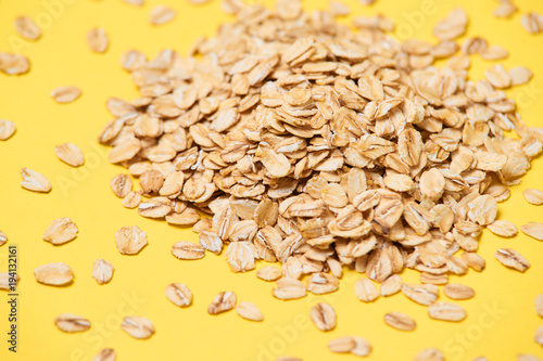 Muesli for breakfast. Healthy food. Yellow bright background. Many flakes