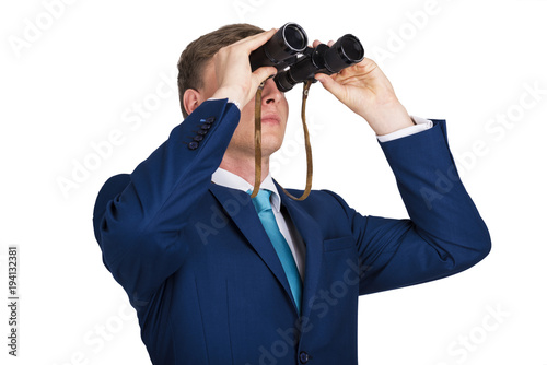 Businessman looking binoculars, blue suit isolated over white background.