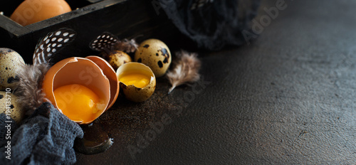 Сhicken and quail eggs in a box photo