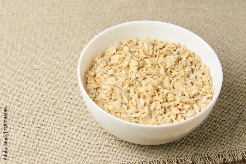 Light background. White bowl. Healthy food. Oatmeal porridge Light background. White bowl. Healthy food. Oatmeal porridge