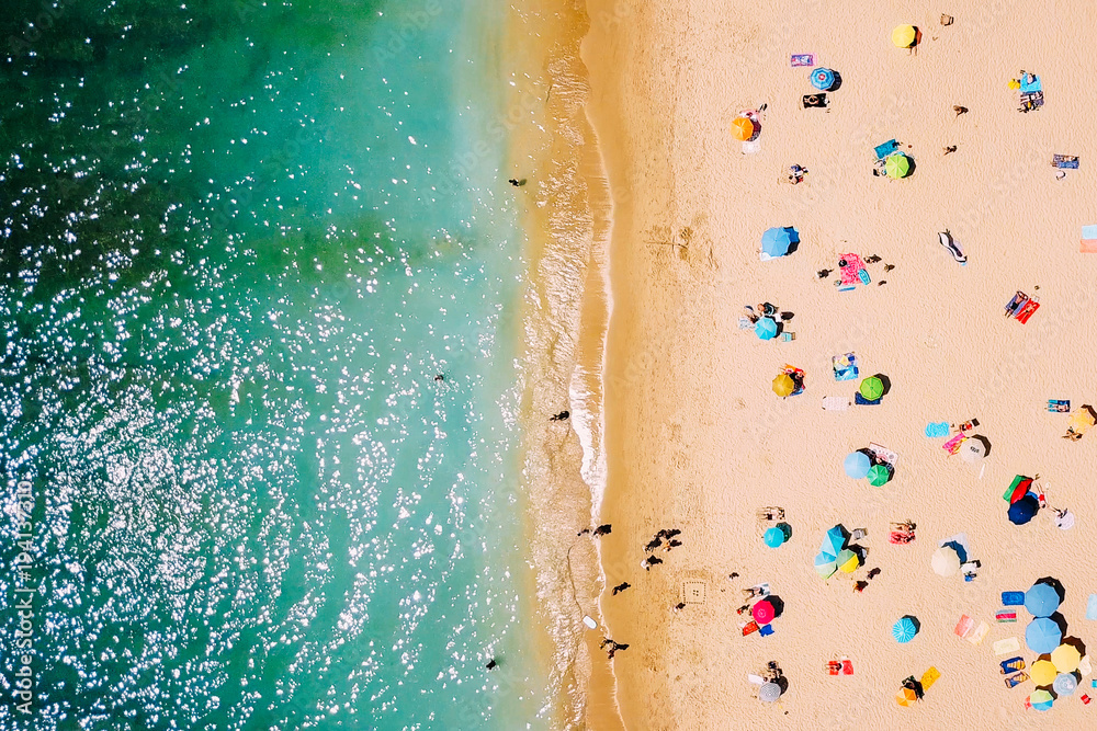 Aerial View From Flying Drone Of People Crowd Relaxing On Beach In Portugal - obrazy, fototapety, plakaty 
