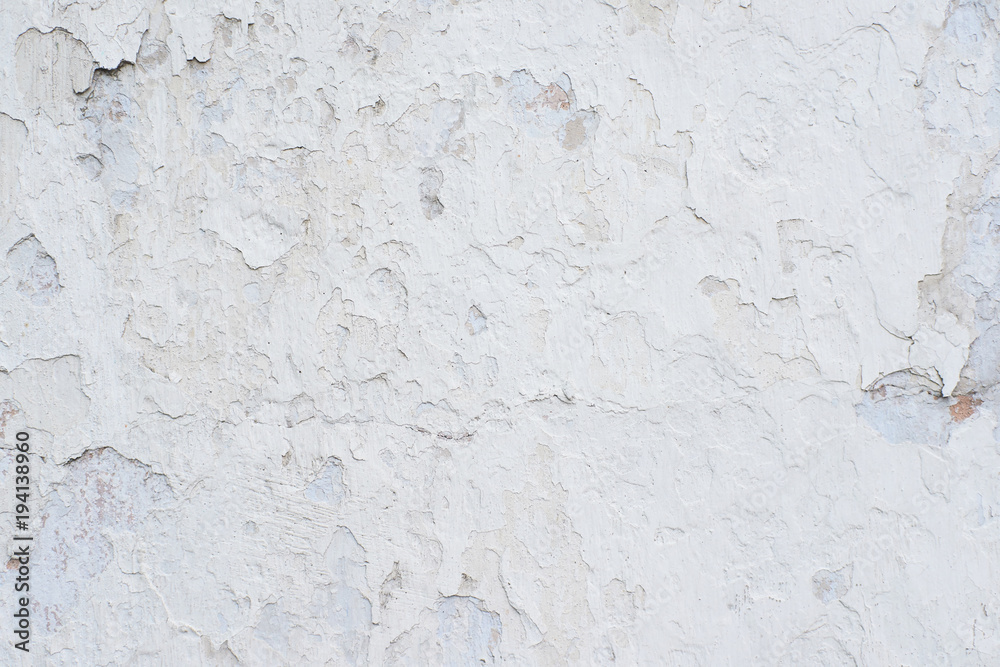 White peeling paint. Many small cracks. Uneven surface