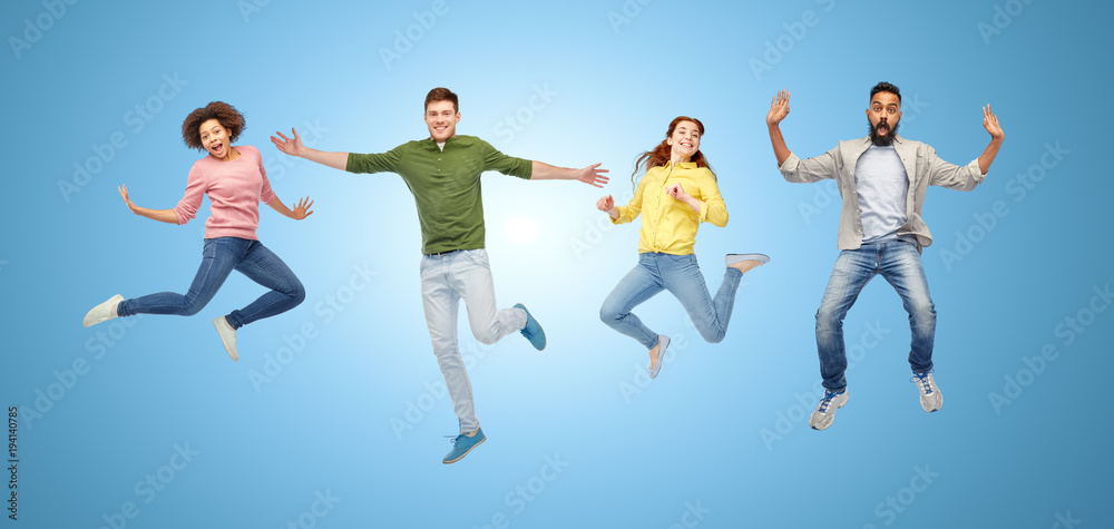happy people or friends jumping in air over blue
