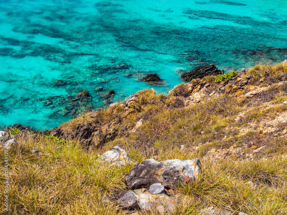 Wonderful seascape. Clear turquoise sea ,coral reef and white sand with green plants on the hill. Wonderful seascape. Clear turquoise sea ,coral reef and white sand with green plants on the hill.