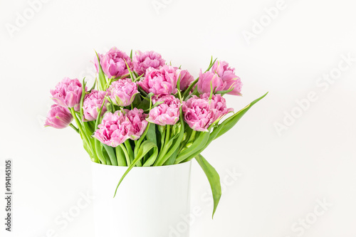 Bouquet of pink tulips in bucket. Fresh spring easter flower. White background , copy space
