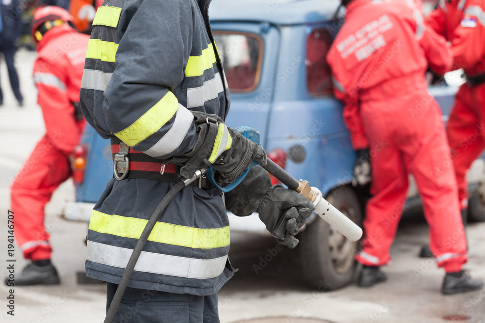 Firefighters in a rescue operation after road traffic accident Firefighters in a rescue operation after road traffic accident