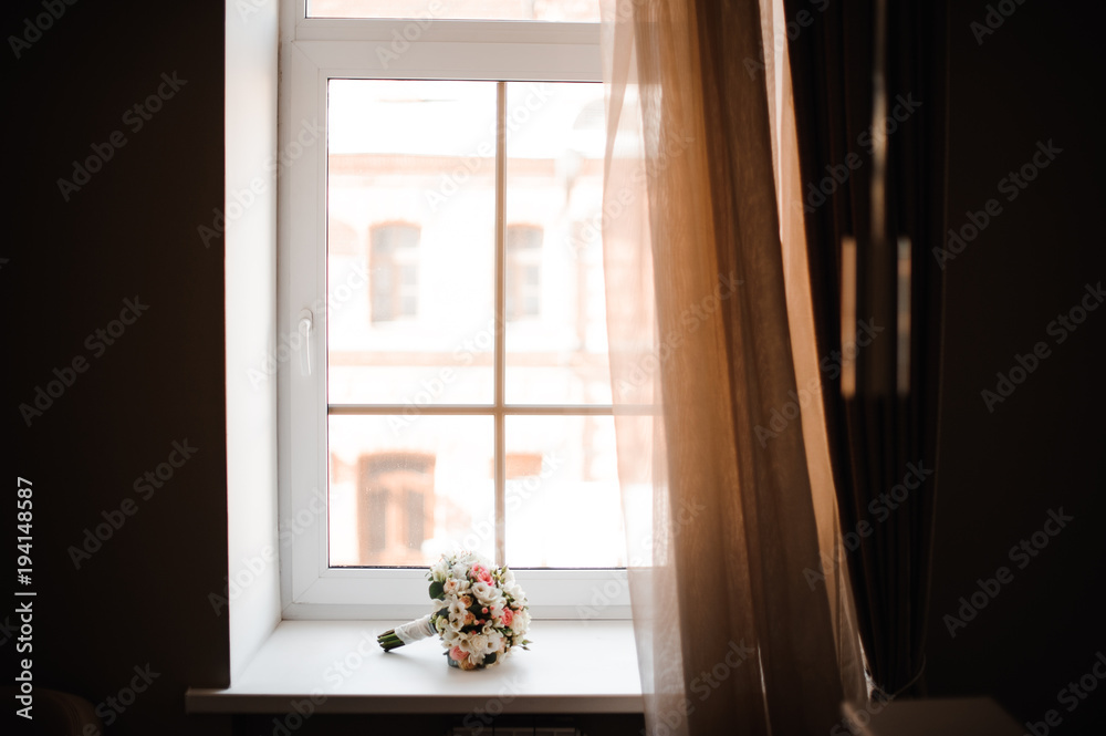 Beautiful wedding bouquet of flowers on the window sill