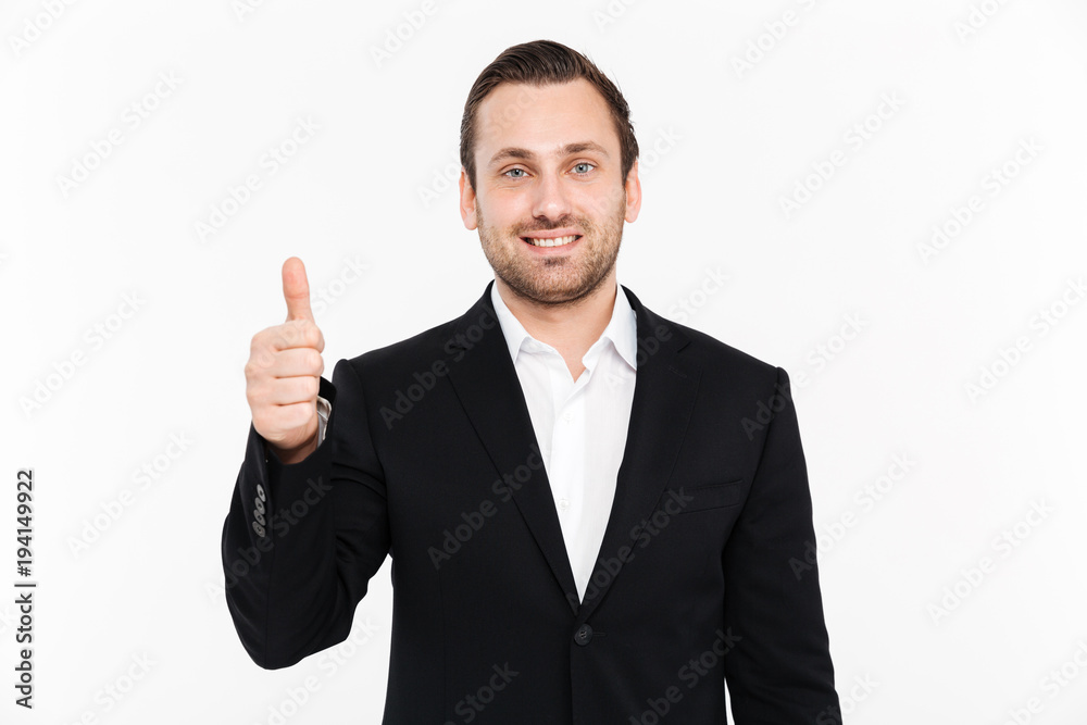 Portrait of happy entrepreneur wearing black formal suit and showing thumb up on camera with smile, isolated over white background Portrait of happy entrepreneur wearing black formal suit and showing thumb up on camera with smile, isolated over white background