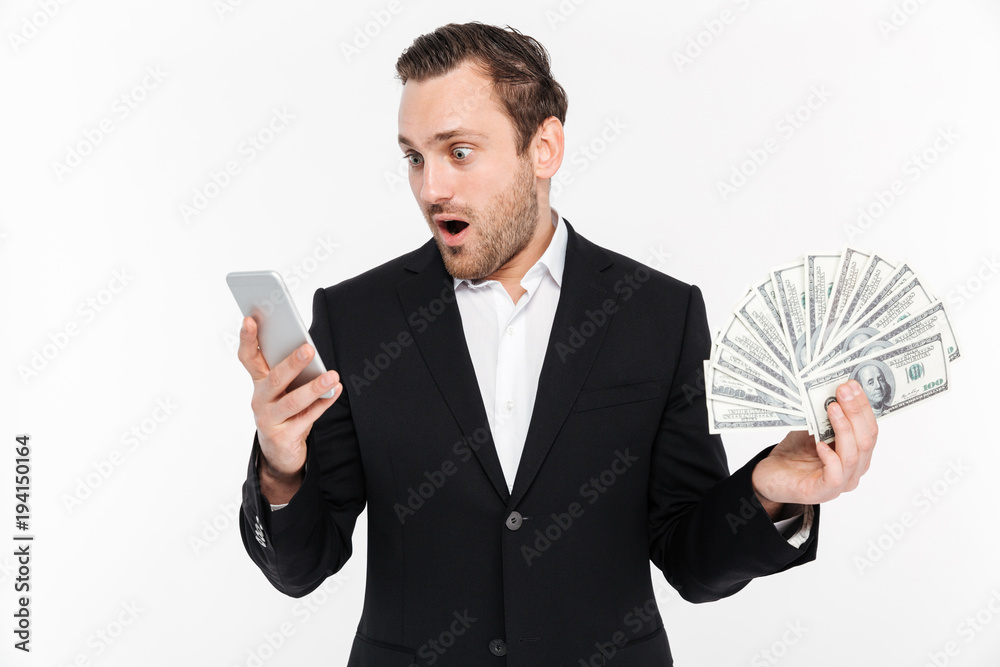 Φωτογραφία Portrait of lucky man in black suit being excited to win lots of money dollar cu