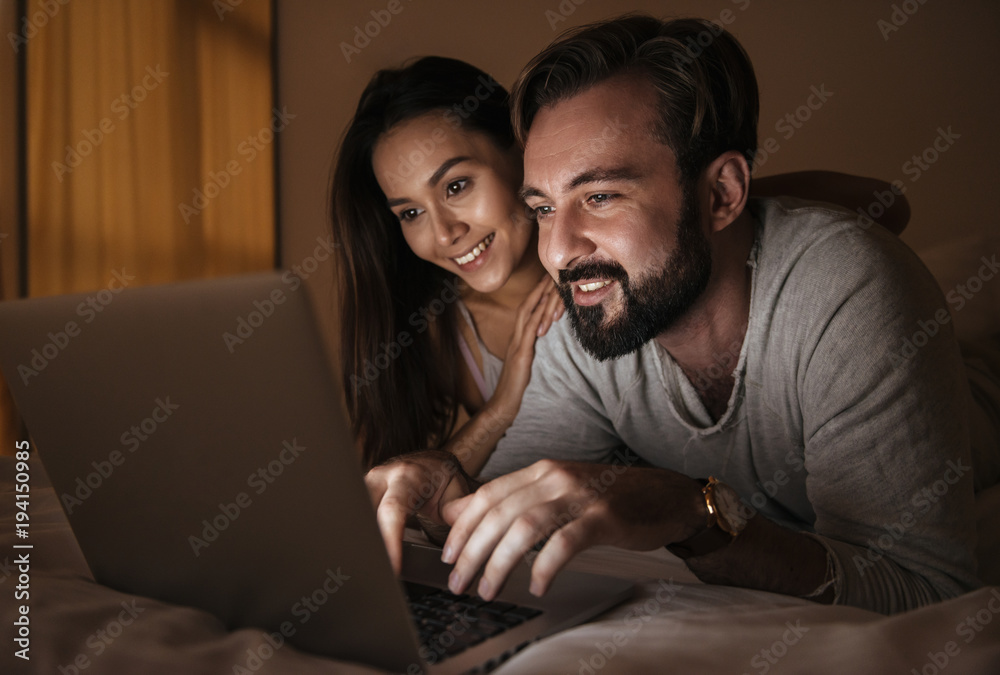 Portrait of a happy young couple using laptop Portrait of a happy young couple using laptop
