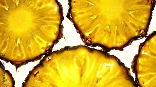 Amazing top view of pineapple fruit slices in flat lay close up, rotating contra clockwise with down center. Excellent food macro background with vibrant texture and backlight in 4k, 3840x2160, clip.