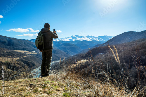 Hiker takes photo of beautiful mountains © Yakov