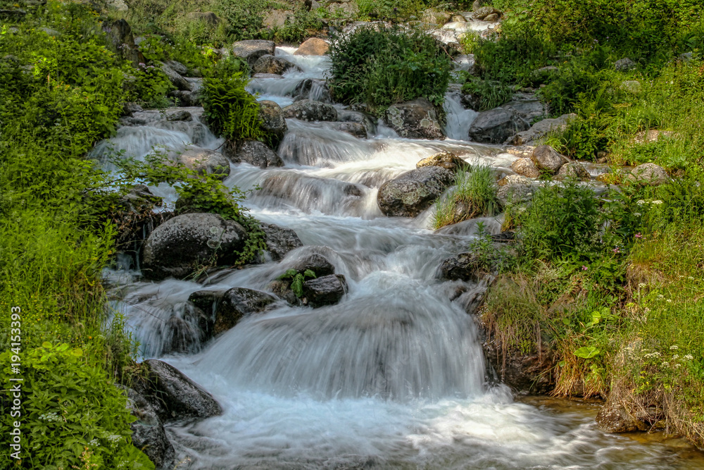 Fototapeta premium River water with rocks and waterfalls
