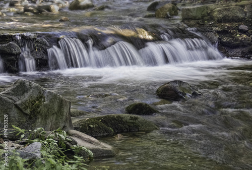 River water with rocks and waterfalls