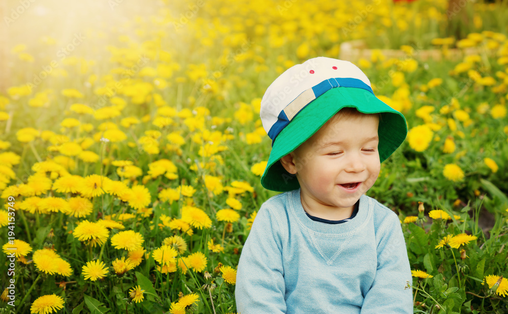 Little boy in hat standing on the field Little boy in hat standing on the field
