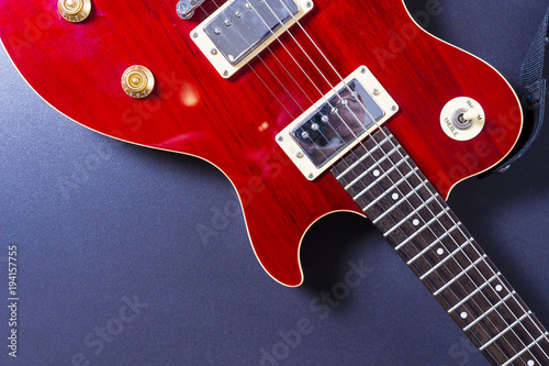 Red electric guitar on black background close-up. Music concept.