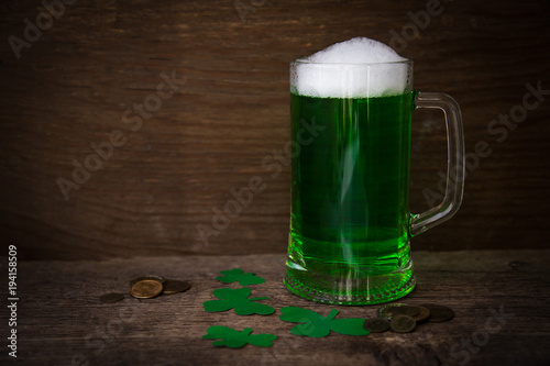 St Patrick's Day concept green beer with shamrock and coins on w