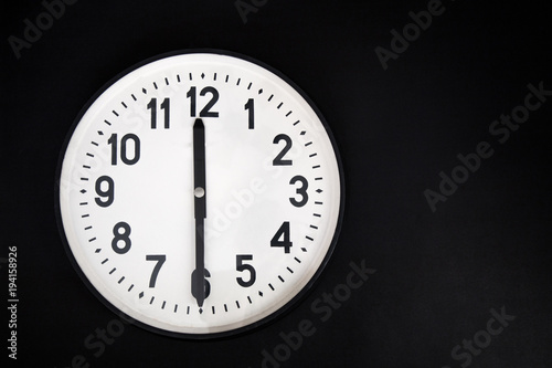 wall clock ion black background . place for text.