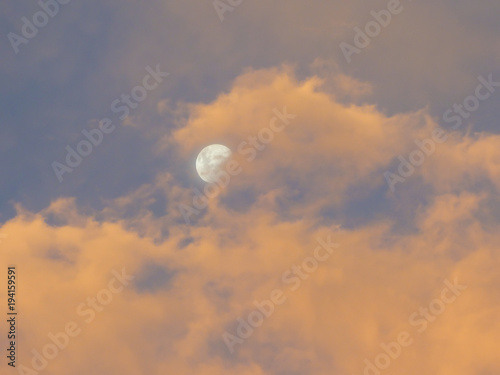 Cloudy pink sunset the moon in Uruguaiana, Brazil