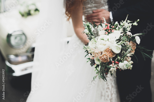 Beauty wedding bouquet with different flowers in hands photo